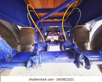 Ipswich, Suffolk / UK - February 25 2020: Semi Truck Trailer Brake Cylinders And Rear Three Axles Airbags Above Them From  Underneath The Trailer. 