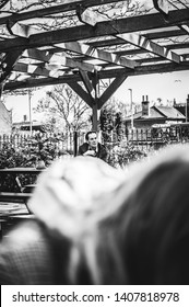 Ipswich Town, Suffolk, England 12/04/2019: Artistic Picture Of A Man Siting In A English Style Pub In A Terrace Outside, Having Paint Of Ice Cold Beer, And Smoking A Cigarette.