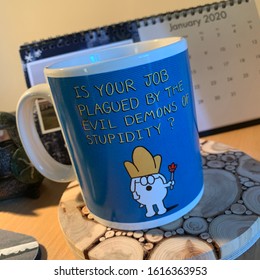 Ipswich, UK - 15 January 2020: Dilbert Mug - Demons Of Stupidity.