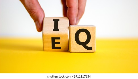 IQ or EQ symbol. Psychologist flips a cube, changes words IQ, intelligence quotient to EQ, emotional quotient. Beautiful white background. Concept of emotional and intelligence quotient. Copy space. - Shutterstock ID 1911117634