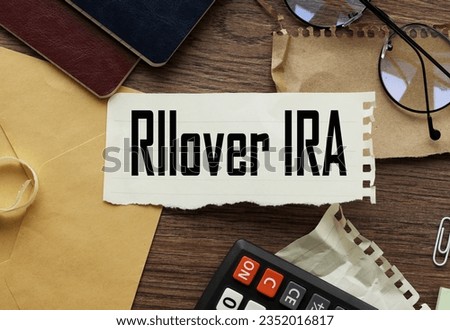 IRA ROLLOVER , business concept torn paper with text on stationery