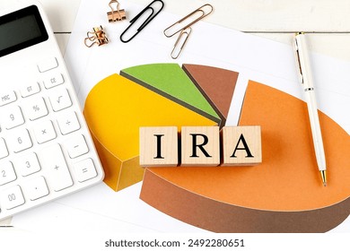 IRA word on wooden block on a chart background . 
