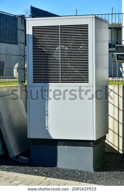 ir-Air Heat Pump for Heating and hot\
Water in Front of an new built Residential\
Building