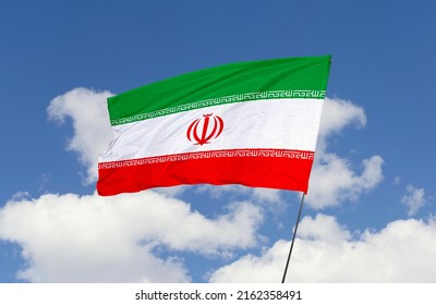 Iran flag is isolated on the blue sky with a clipping path. flag symbols of Iran.