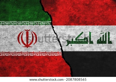 Iran and Iraq painted flags on a wall with a crack. Iraq and Iran conflict. Iran and Iraq relations. Iran vs Iraq