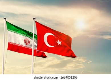 Iran Turkey National Flag Cloth Fabric Waving On The Sky With Beautiful Sun Light - Image