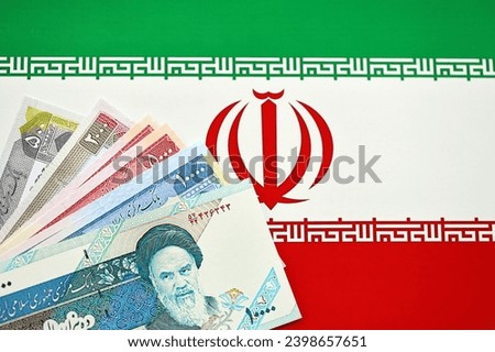 Iranian Rial IRR banknotes from Iran on flag of Islamic Republic of Iran close up