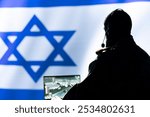 Iranian spy in control room uses military tech to identify threats during Arab Israeli conflict. Mossad intelligence agent uses software to relay info to generals on war front line