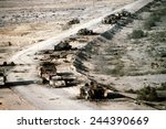 Iraqi armored personnel carriers tanks and trucks destroyed in a Coalition attack along a road in the Euphrates River Valley during Operation Desert Storm. March 4 1991