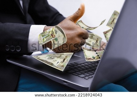 Iraqi dinar notes coming out of laptop with Business man giving thumbs up, Financial concept. Make money on the Internet, working with a laptop