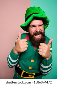 Ireland Beer Tradition. Winter Carnival. Irish Pub Party. St Patricks Day. Happy Bearded Hipster In Green Hat. Christmas Elf. Happy Celebration. Cheerful Man With Beard Have Fun Show Thumb Up.