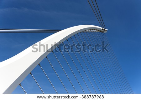 Ireland, Dublin, Liffey river: Detail of the famous Samuel Beckett Bridge (Harp) in the Irish capital with blue sky in background - landmark icon