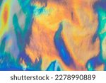 Iridescent rainbow-colored texture with a shining surface. Abstract background