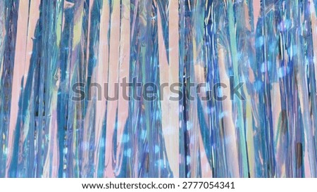 Iridescent tinsel stream creating an abstract shimmering light background