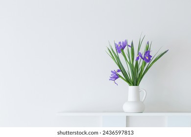 irises in white jug on white background - Powered by Shutterstock