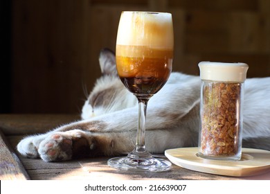 Irish Coffee Cocktail In A Glass With Sleeping Cat