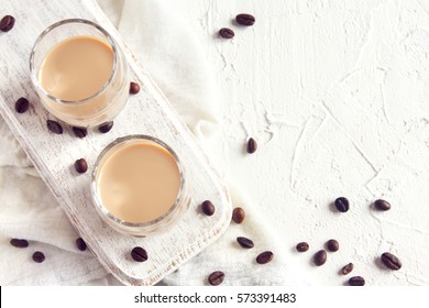 Irish Cream Coffee Liqueur And Coffee Beans Over White Wooden Background - Homemade Festive Alcoholic Drink