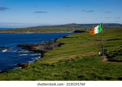 Irish flag at the hiking trail leading from Doolin to the Cliffs of Moher, County Clare, Ireland
