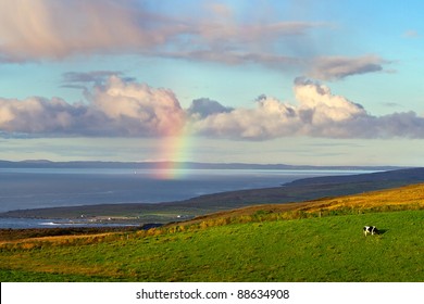 Irish Landscape With Rainbow Over The Ocean
