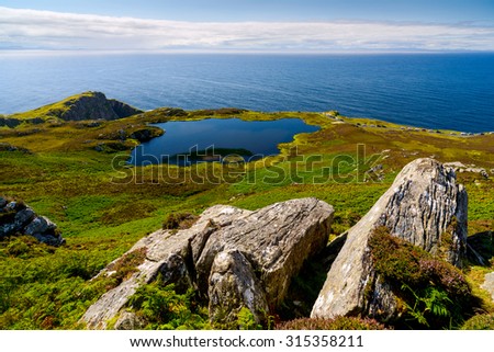 Irish landscape with rocks, lake and sea, County Donegal