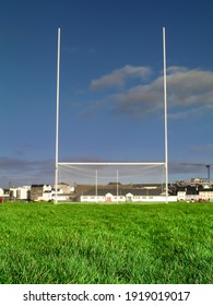 Irish Sport Tall Goal Posts In A Field On A Bright Sunny Day. Galway City, Ireland. South Park. Camogie, Hurling And Rugby Training Ground. Blue Cloudy Sky. Selective Focus