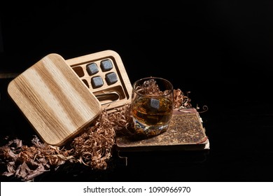 Irish whiskey. Glass of whisky with wiskey stones. Elegant glass of whiskey with Whiskey stones. Scotch Whisky in the glass. Irish Whiskey with oak box.
