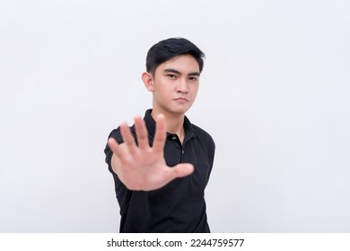 An irked or demanding man commands to stop, putting his hand forward. Isolated on a white background. - Shutterstock ID 2244759577