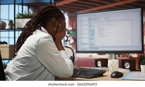 Irked software developer frustrated while coding, struggling to implement algorithms. Unhappy IT expert annoyed while working with code editor, unable to optimize performance, camera A