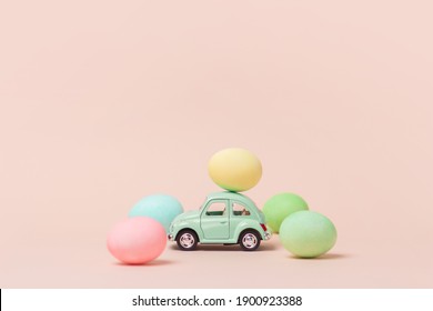 Irkutsk, Russia - January 17, 2021: Light Green Retro Toy Car Carries Easter Egg. Happy Easter Card With Abstract Minimal Scene With Easter Eggs In Cream Colors.