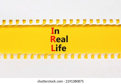 IRL In Real Life Symbol. Concept Words IRL In Real Life On Yellow Paper On A Beautiful White Background. Business And IRL In Real Life Concept. Copy Space.