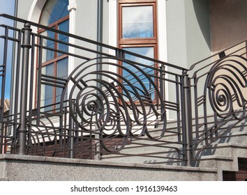 Iron banister. Elements railing of a staircase сlose up. entrance to the building. Iron banister.