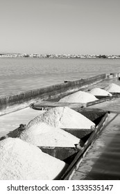 iron barges loaded with heaps of coarse salt just extracted from the lagoon. Black and white photo