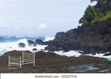 Iron Bed Frame On Beach Rocks
