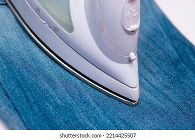 Iron And Blue Jeans. Ironing Pants