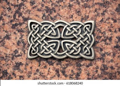 Iron Cast Celtic Knot On A Stone Surface. 