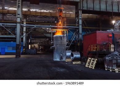 Iron casting and the foundry. Overhead crane with ladle with molten metal at metallurgical factory. - Powered by Shutterstock