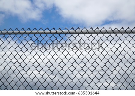 iron chain link fence against sky