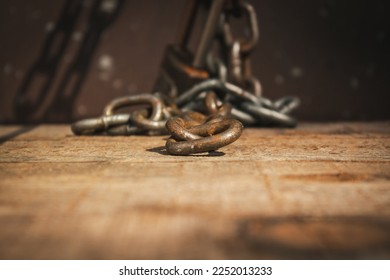 Iron chain lock on wooden floor. Rusty chain lock. 