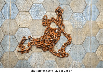 iron chains rusting from temperature changes on the tiled floor