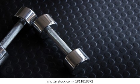 Iron Dumbbell On Rubber Floor At Gym