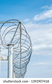 Iron Fence With Barbed Tape On Blue Sky