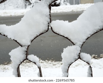 iron fence under white snow close-up - winter season - Shutterstock ID 2269565785