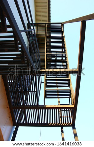 iron fire exit outdoor.the steel structure fire escape ladder outof building.emergency way leaving the tower when has problem.