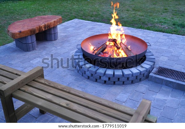 Iron\
fire pit and burning fire in fire place  a garden\
.