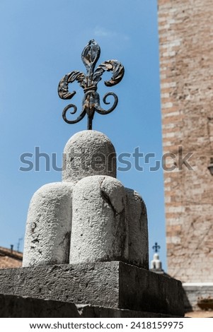 Iron fleur de lys as building decoration in Italy.