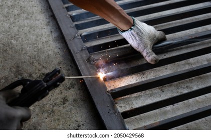 Iron Gate Repair, Worker Hand Welding Steel