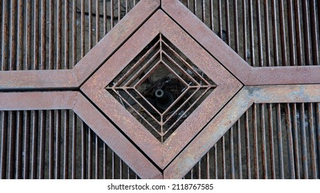 Iron Grate Of A Drainage System For Storm Water Drainage In Side A Pedestrian Sidewalk