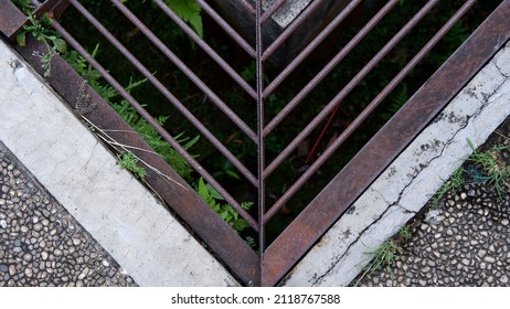 Iron Grate Of A Drainage System For Storm Water Drainage In Side A Pedestrian Sidewalk