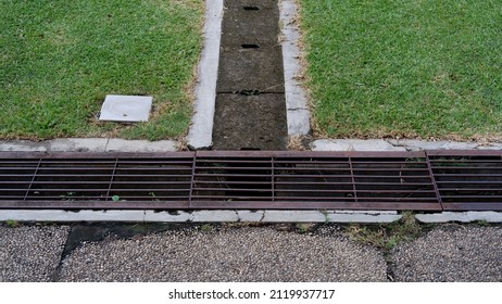 Iron Grate Of A Drainage System For Storm Water Drainage In Side A Pedestrian Sidewalk