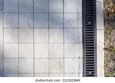 Iron Grate Of A Drainage System For Storm Water Drainage From A Pedestrian Footpath In A Public Park.